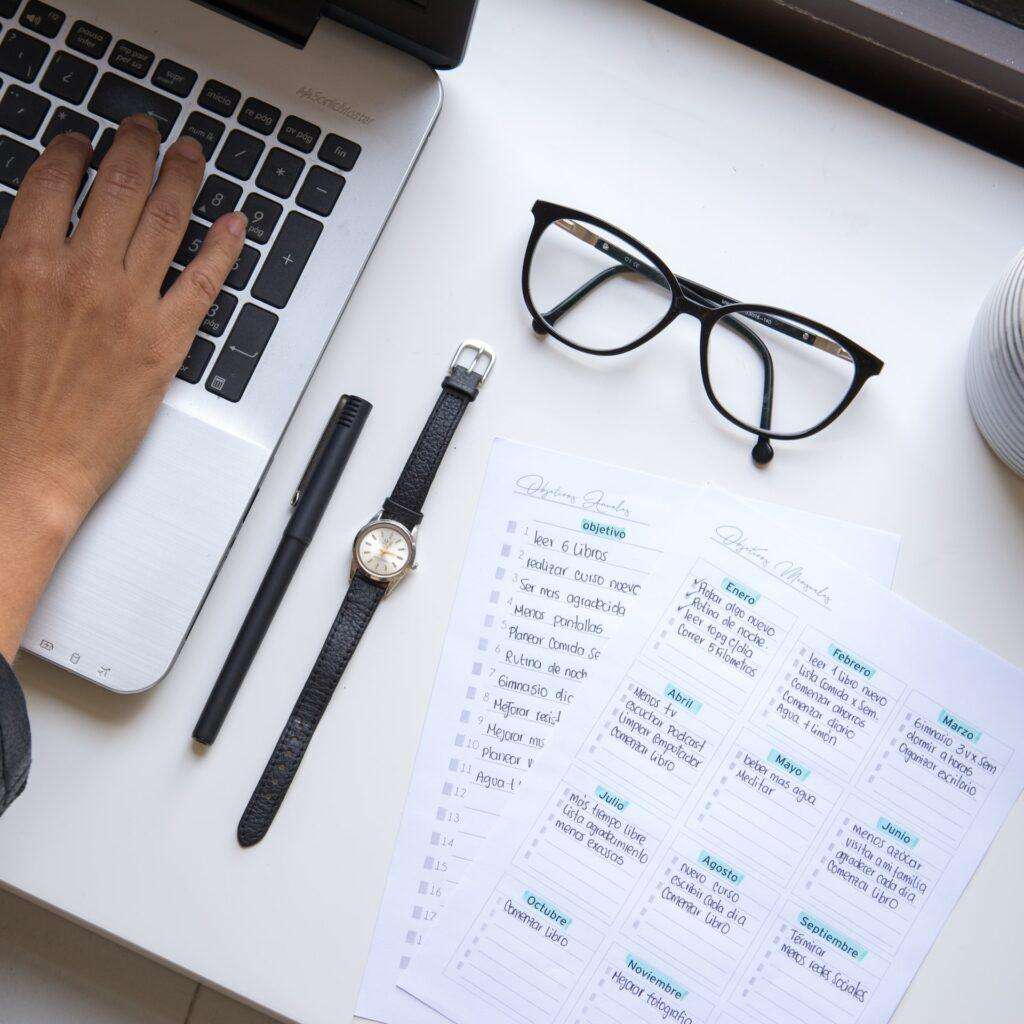 Prospective business owner registering her company in Singapore with documentation and with a watch on a desk to see how long it takes.