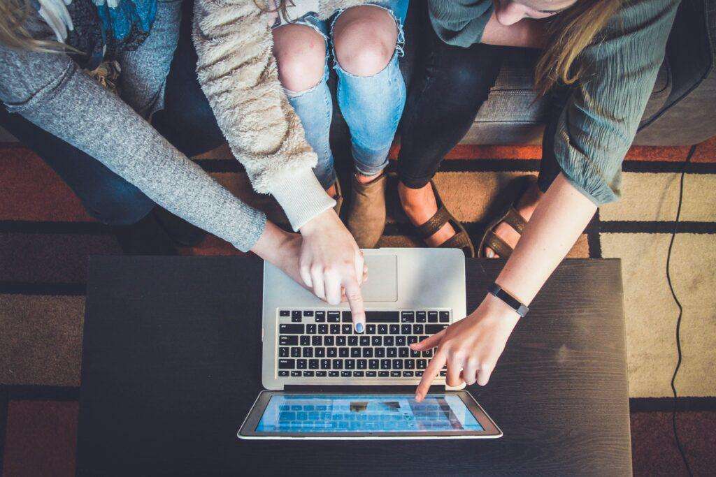 Business partners networking on a laptop to reach success with their Singapore businesses